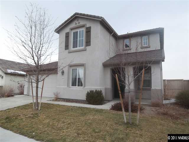 10641 Fire Poppy Circle Reno, NV 89521 - Photo 1 of 13 a front view of a house with garden