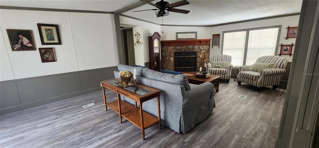 19865 Southwest 5th Place Dunnellon, FL 34431 - Photo 27 of 78 a living room with furniture a large window and a flat screen tv