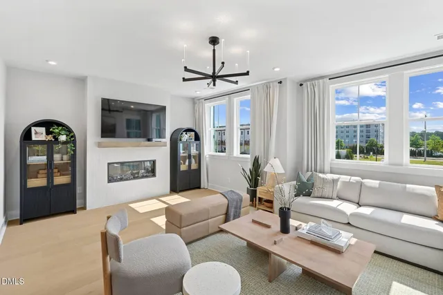 a kitchen with stainless steel appliances kitchen island granite countertop a refrigerator a sink a stove and a wooden floors