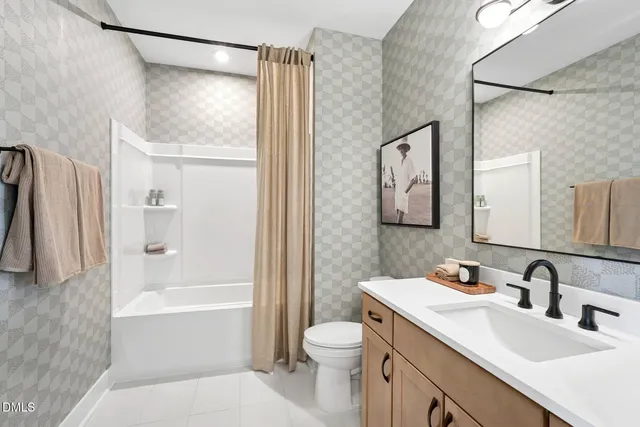 a living room with furniture a ceiling fan and a window