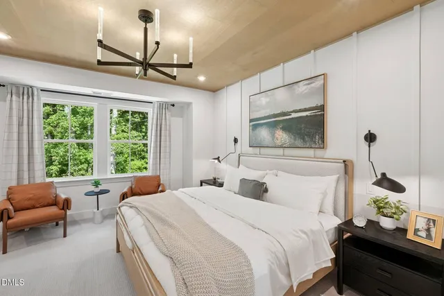 a living room with furniture windows and a chandelier