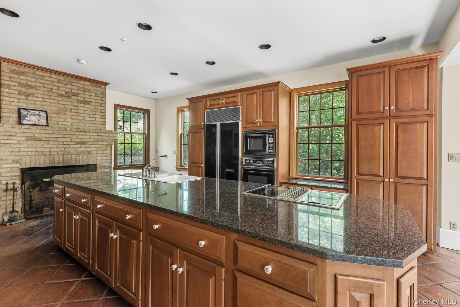81 Glendale Road Ossining, NY 10562 - Photo 11 of 37 Dark granite countertops, wb fireplace, recessed lighting and plenty of storage