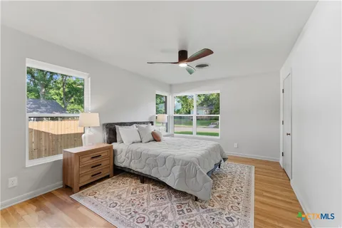 a bedroom with a bed and wooden floor