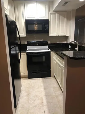 a kitchen with a stove microwave and sink