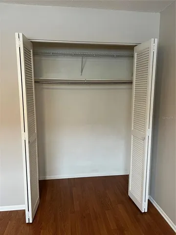 an empty room with wooden floor