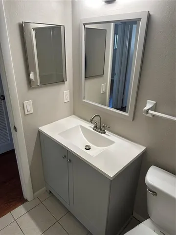 a bathroom with a sink toilet and mirror