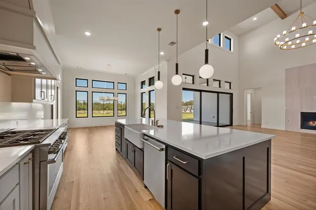 a kitchen with stainless steel appliances granite countertop a stove and a refrigerator