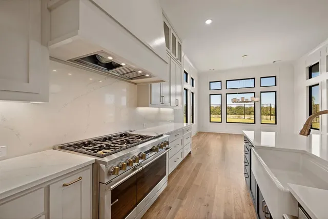 a kitchen with kitchen island a sink appliances and a counter top space