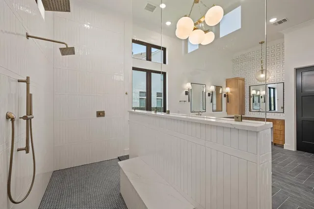 a large bathroom with a double vanity sink and a mirror