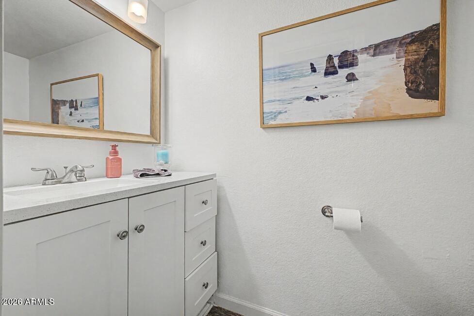 860 North McQueen Road, Unit 1135 Chandler, AZ 85225 - Photo 18 of 24 a bathroom with a sink mirror and vanity