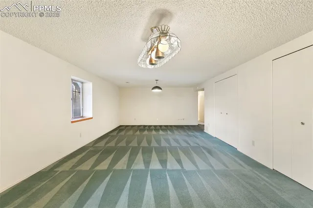 a view of a room with wooden floor and white walls