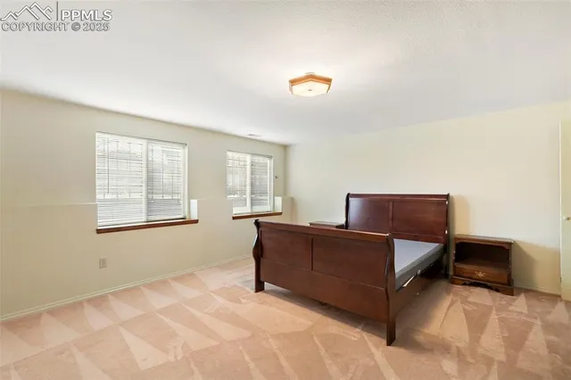 a bedroom with a bed and dresser with mirror