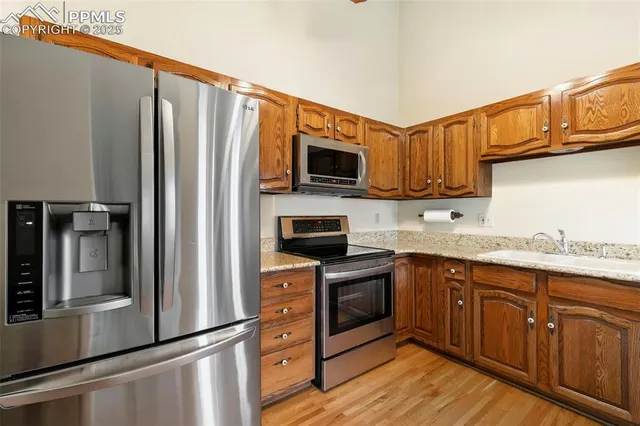 a metallic refrigerator freezer sitting in a kitchen