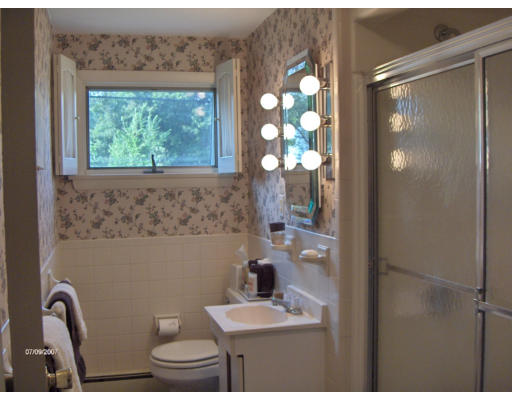 21 Irving Road Natick, MA 01760 - Photo 6 of 13 a bathroom with a granite countertop sink a toilet and a window