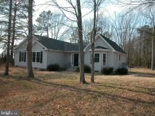 a view of a house with a yard and large tree