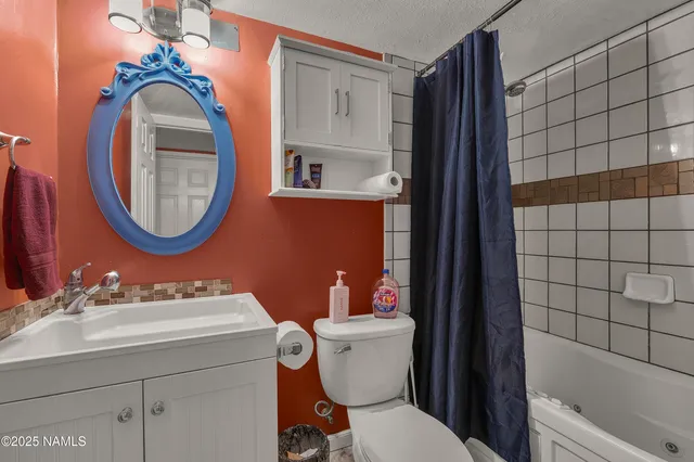 a bathroom with a sink mirror vanity and toilet