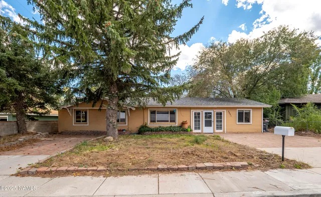 a view of a house with a tree