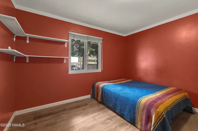 a bedroom with bed and a window