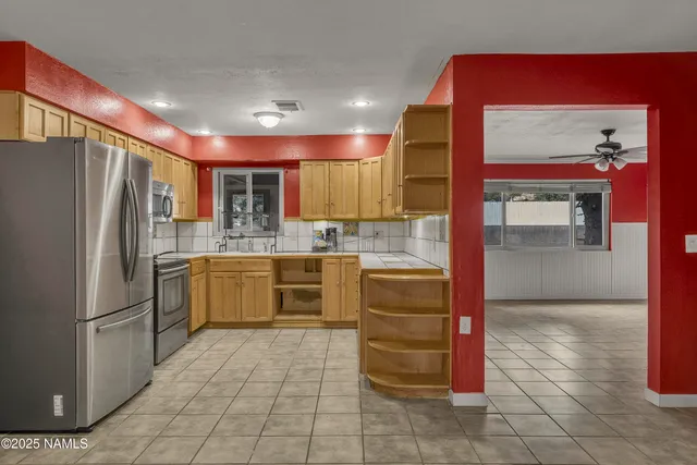 a kitchen with stainless steel appliances granite countertop a refrigerator and a sink