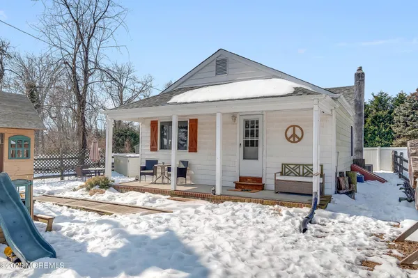 a building outdoor space with patio furniture and potted plants