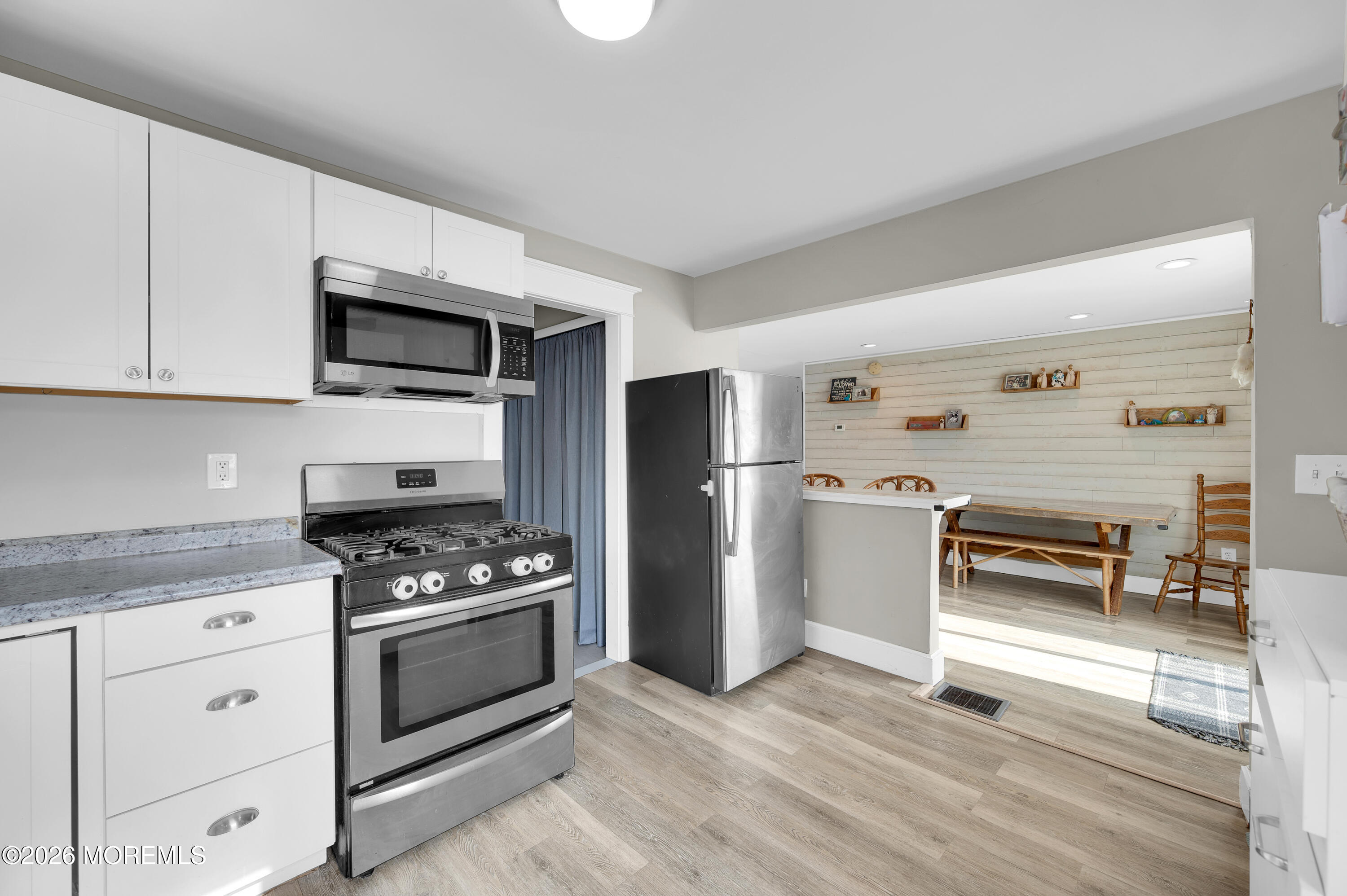 1429 Marconi Road Wall, NJ 07719 - Photo 4 of 21 a kitchen with granite countertop a refrigerator and a stove top oven