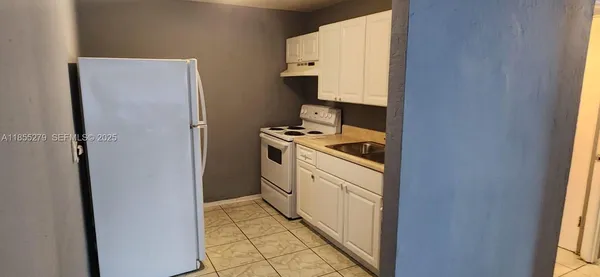a utility room with cabinets washer and dryer