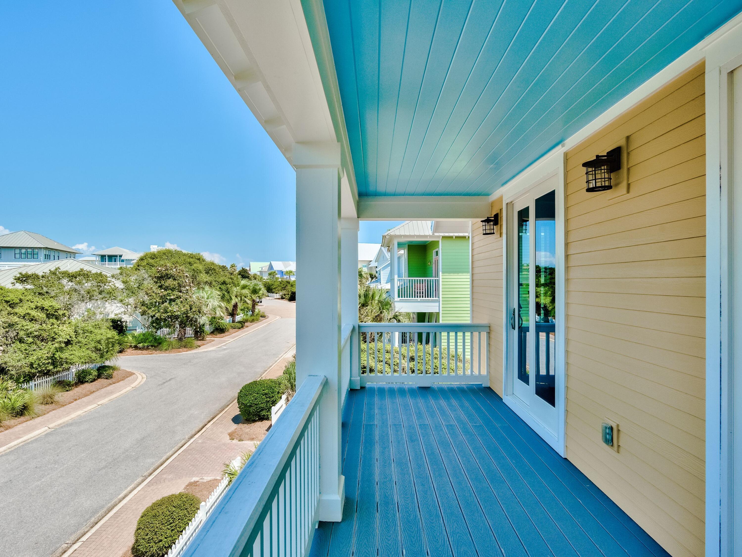 477 Old Beach Road Santa Rosa Beach, FL 32459 - Photo 27 of 35 a porch with furniture and wooden floor