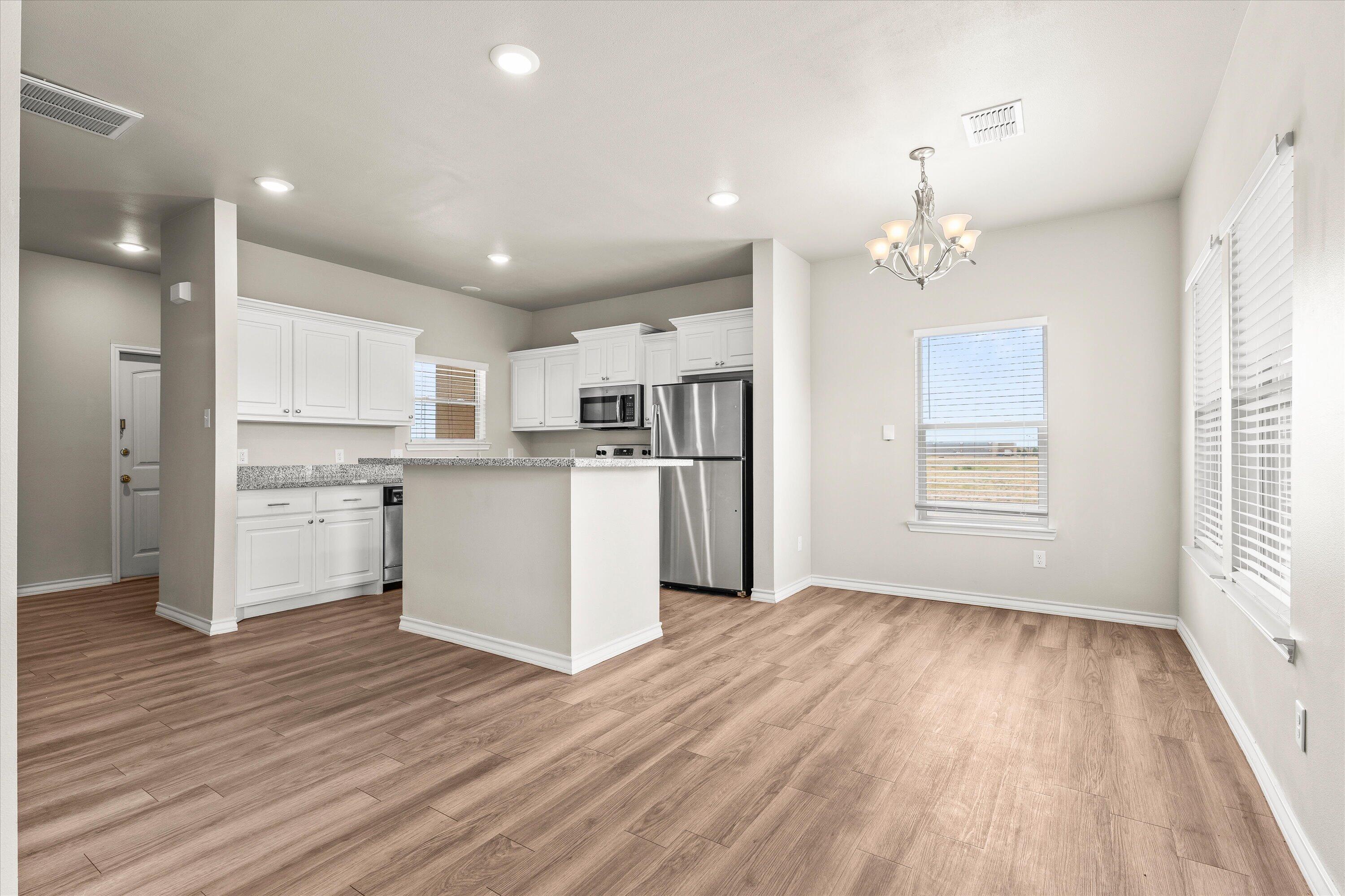 a view of a kitchen with wooden floor
