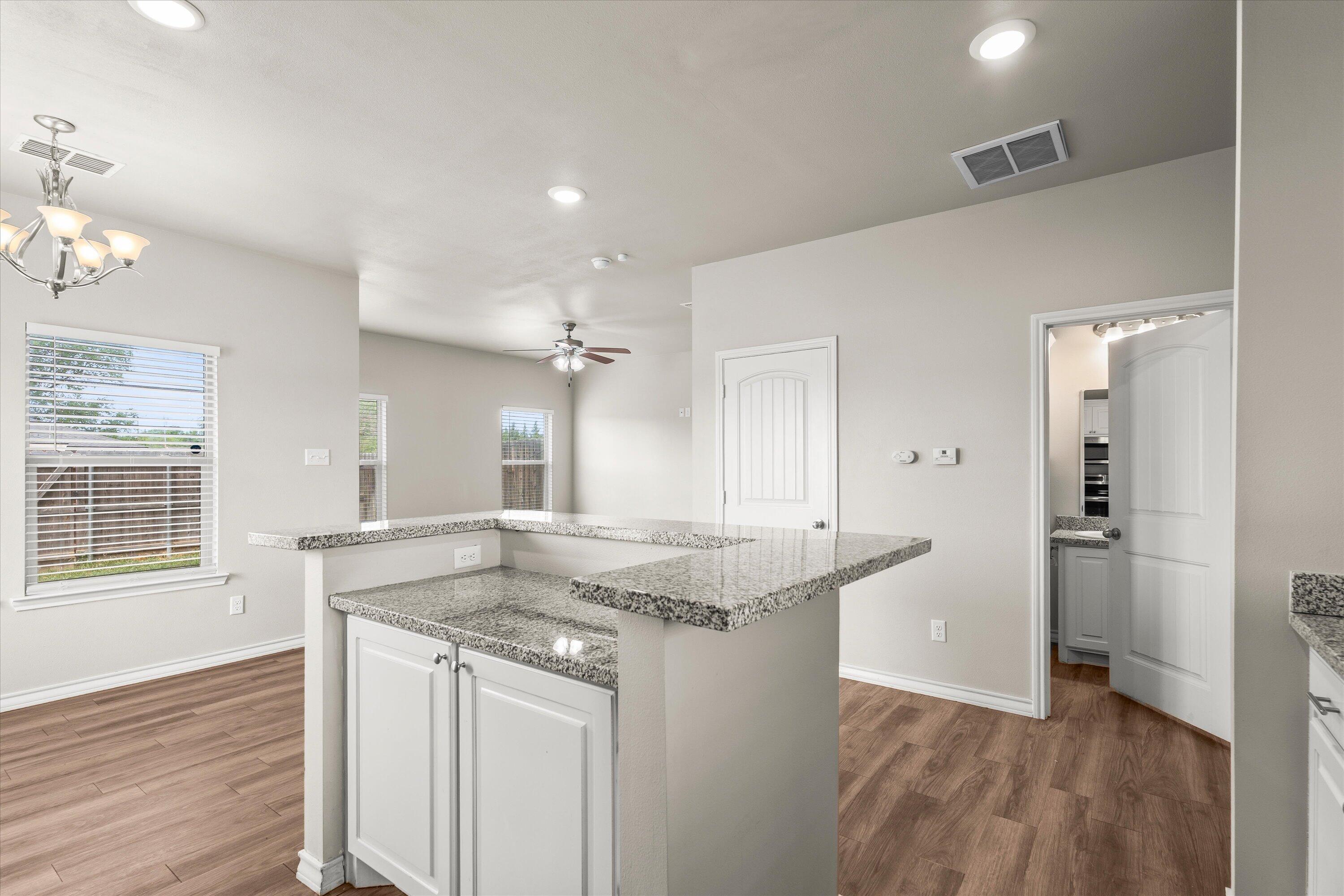 6040 24th Street, Unit 10 Lubbock, TX 79407 - Photo 14 of 29 a view of a kitchen cabinets and wooden floor