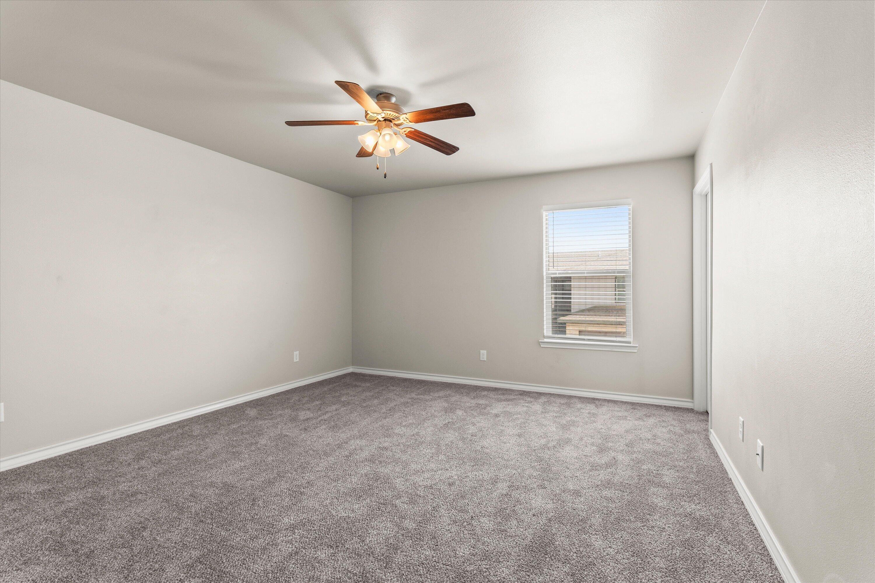 6040 24th Street, Unit 10 Lubbock, TX 79407 - Photo 17 of 29 an empty room with windows and fan