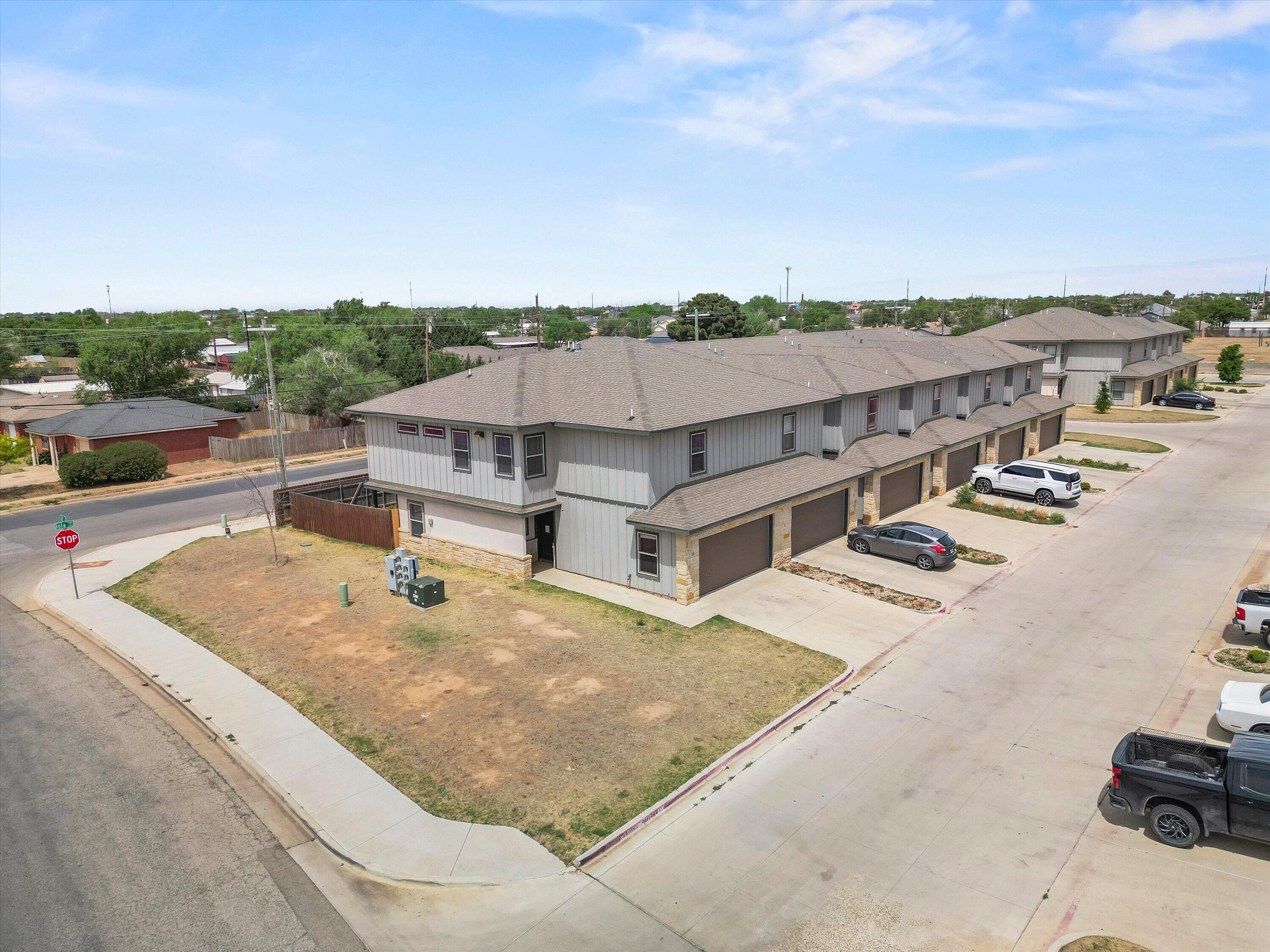 6040 24th Street, Unit 10 Lubbock, TX 79407 - Photo 2 of 29 an aerial view of a house with ocean view