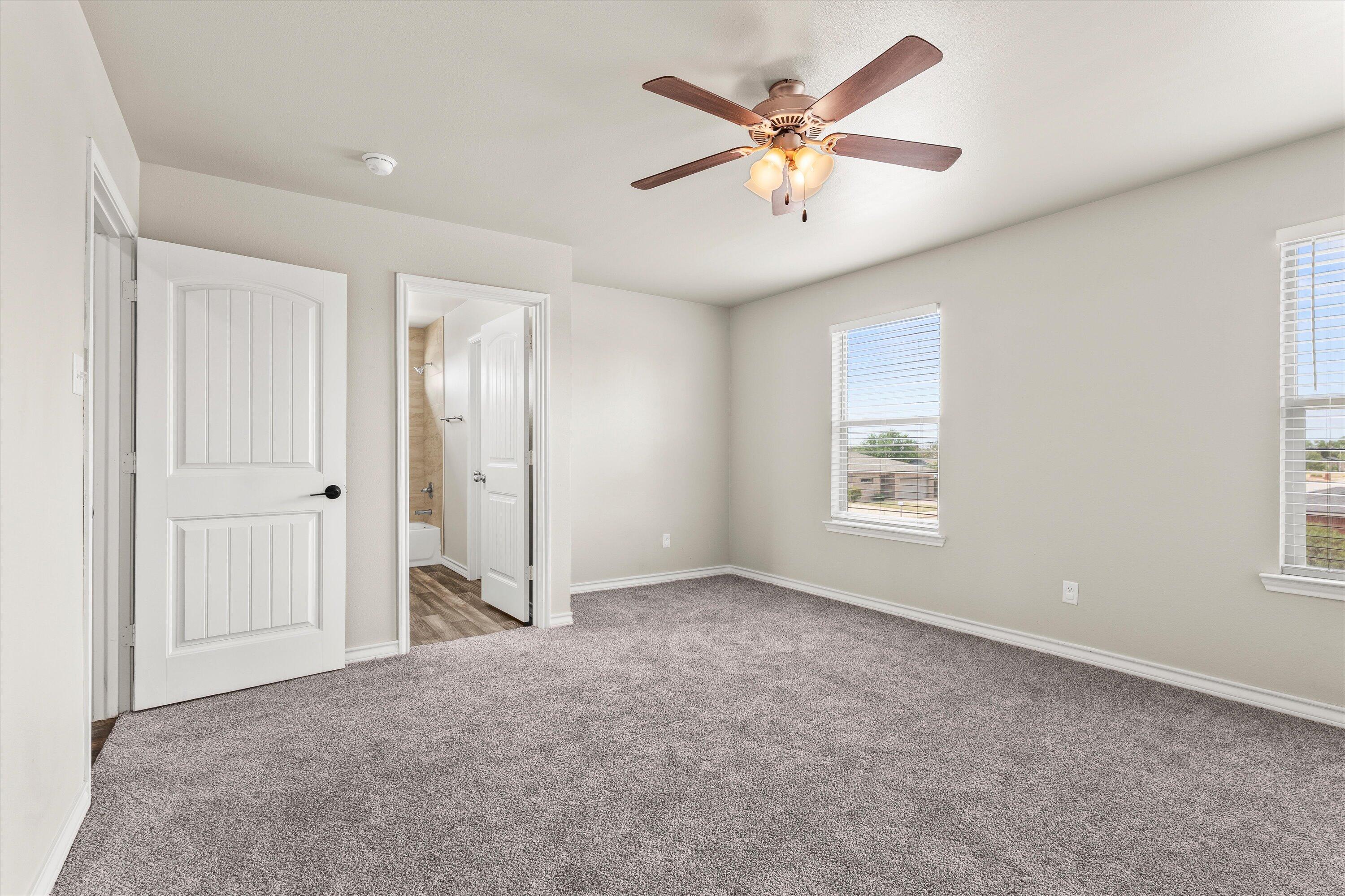 6040 24th Street, Unit 10 Lubbock, TX 79407 - Photo 24 of 29 an empty room with fan and windows