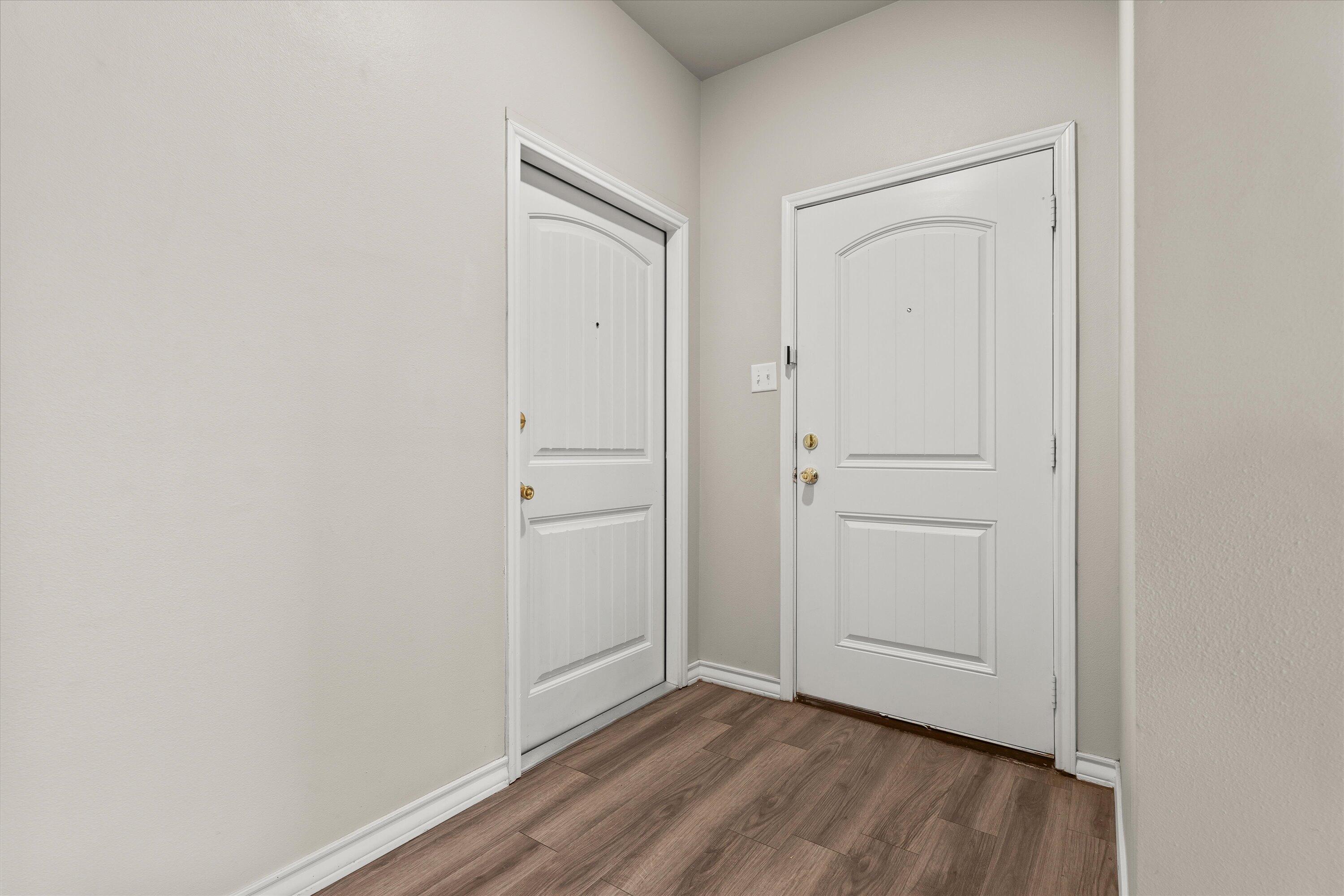 6040 24th Street, Unit 10 Lubbock, TX 79407 - Photo 7 of 29 a view of an empty room and wooden floor