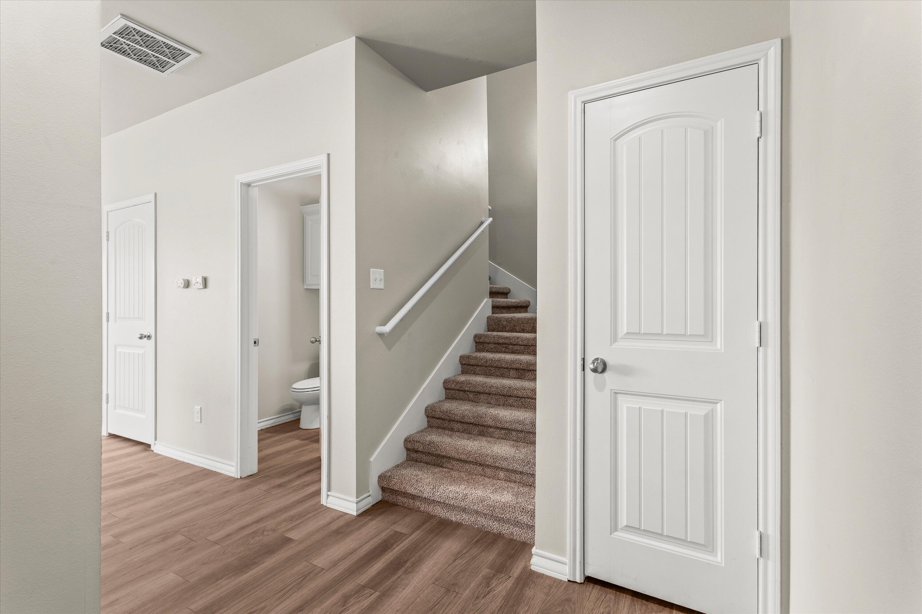 6040 24th Street, Unit 10 Lubbock, TX 79407 - Photo 8 of 29 a view of a hallway with wooden floor and entryway