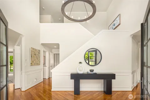 a view of a hallway with entryway wooden floor and front door