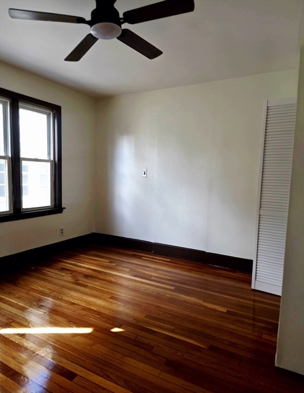 63 Evans Street, Unit 2 Boston, MA 02124 - Photo 14 of 18 a view of an empty room with wooden floor and a window