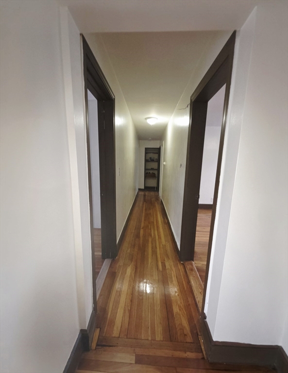 63 Evans Street, Unit 2 Boston, MA 02124 - Photo 4 of 18 a view of a hallway with wooden floor