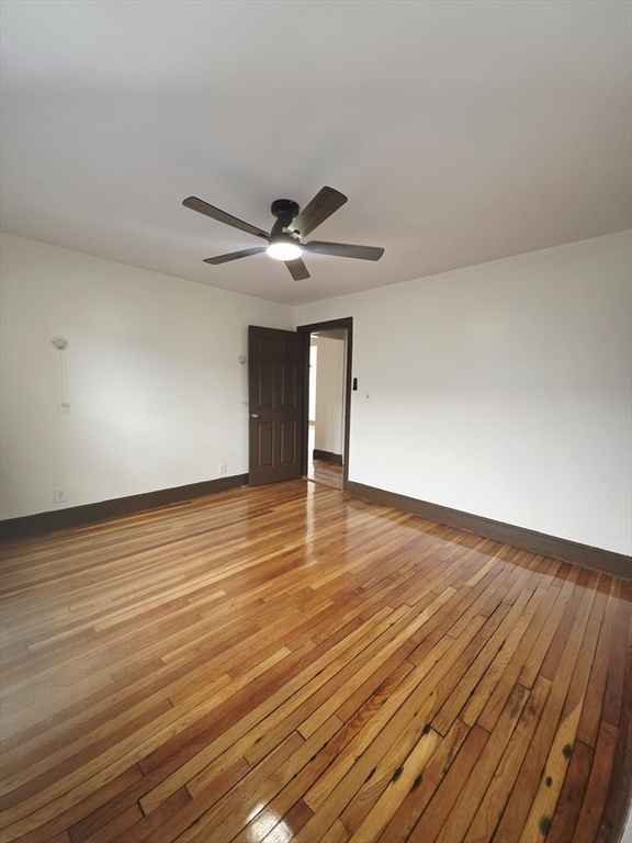 63 Evans Street, Unit 2 Boston, MA 02124 - Photo 5 of 18 a view of an empty room and wooden floor