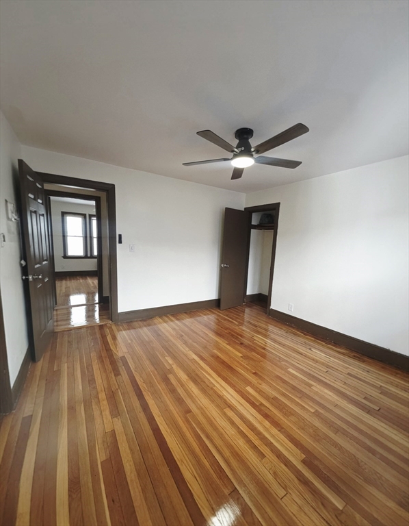 63 Evans Street, Unit 2 Boston, MA 02124 - Photo 6 of 18 a view of empty room with wooden floor and fan