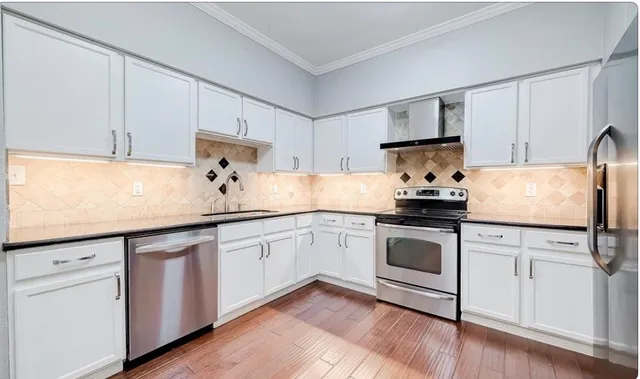 a kitchen with granite countertop white cabinets and white appliances
