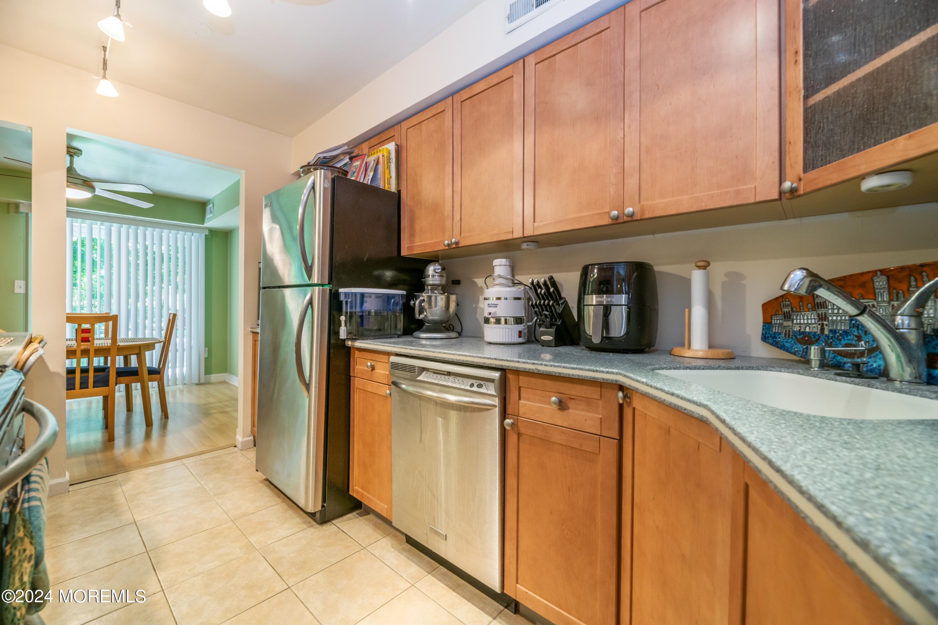 200 Portland Road, Unit D10 Highlands, NJ 07732 - Photo 12 of 16 a kitchen with stainless steel appliances granite countertop a refrigerator and a sink