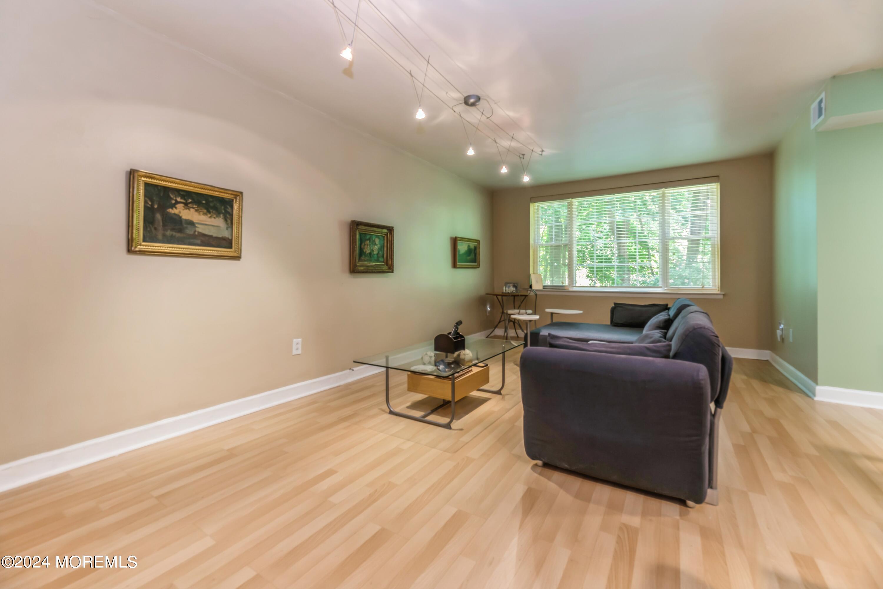 200 Portland Road, Unit D10 Highlands, NJ 07732 - Photo 8 of 16 a living room with furniture and a large window