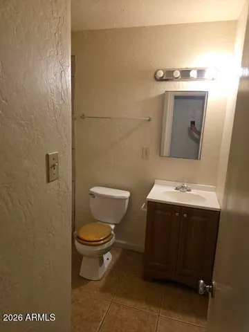 a white toilet sitting next to a bath tub