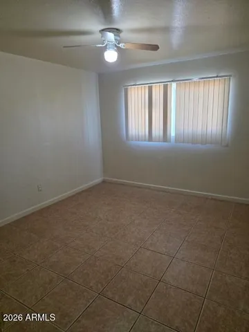 a view of an empty room with a ceiling fan