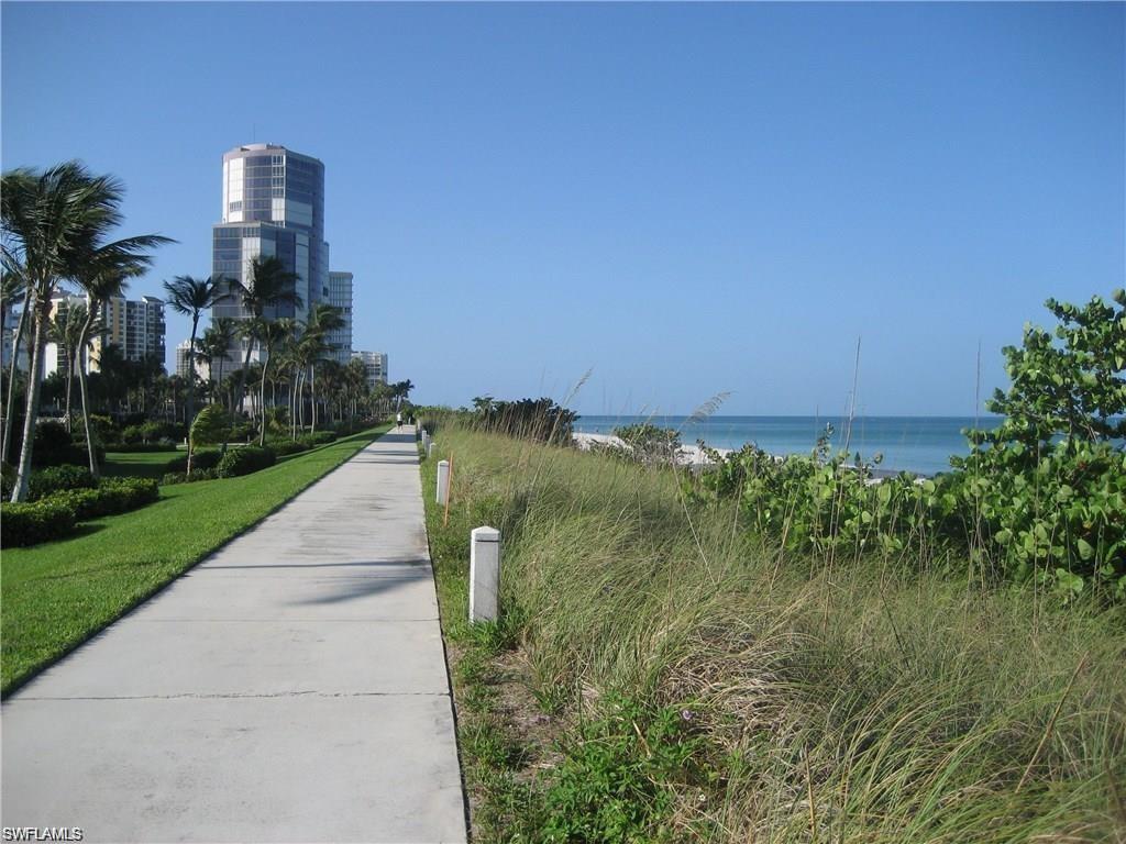 4160 Crayton Road, Unit A1 Naples, FL 34103 - Photo 15 of 17 a view of a lake with a building in front of it