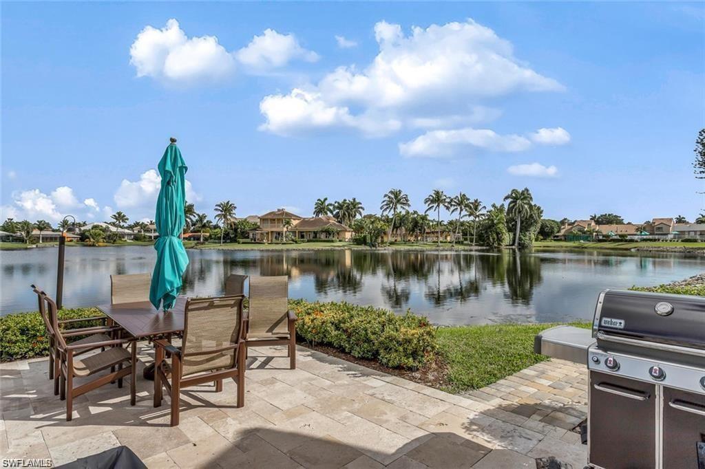 4160 Crayton Road, Unit A1 Naples, FL 34103 - Photo 16 of 17 a lake view with tables and chairs