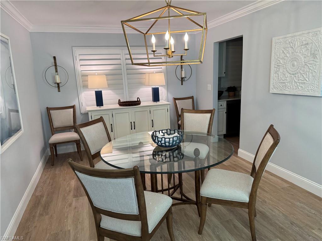 4160 Crayton Road, Unit A1 Naples, FL 34103 - Photo 3 of 17 a dining room with furniture and window