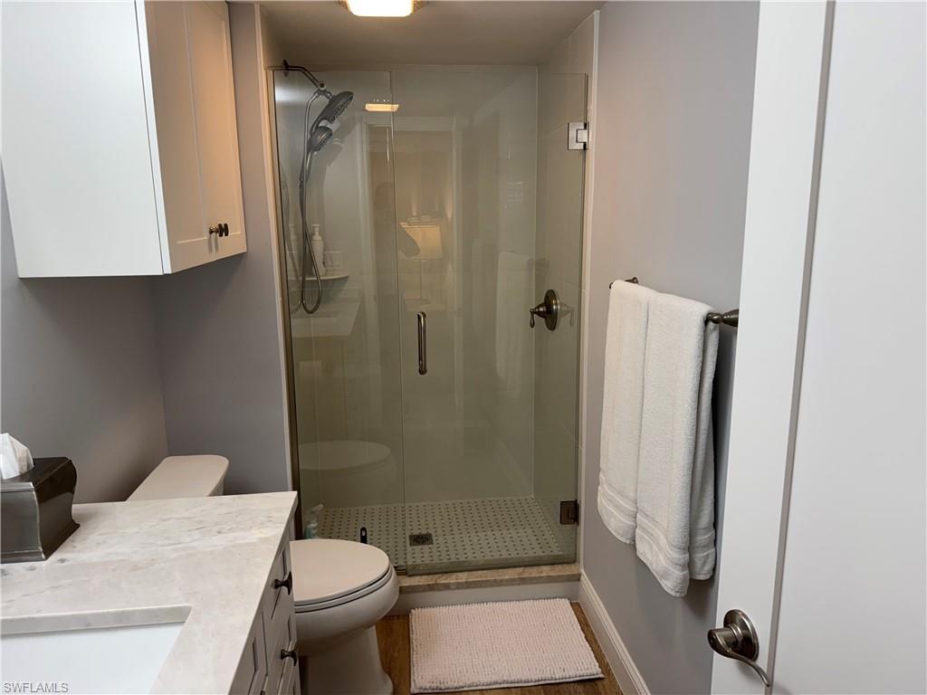 4160 Crayton Road, Unit A1 Naples, FL 34103 - Photo 6 of 17 a bathroom with a sink toilet and shower