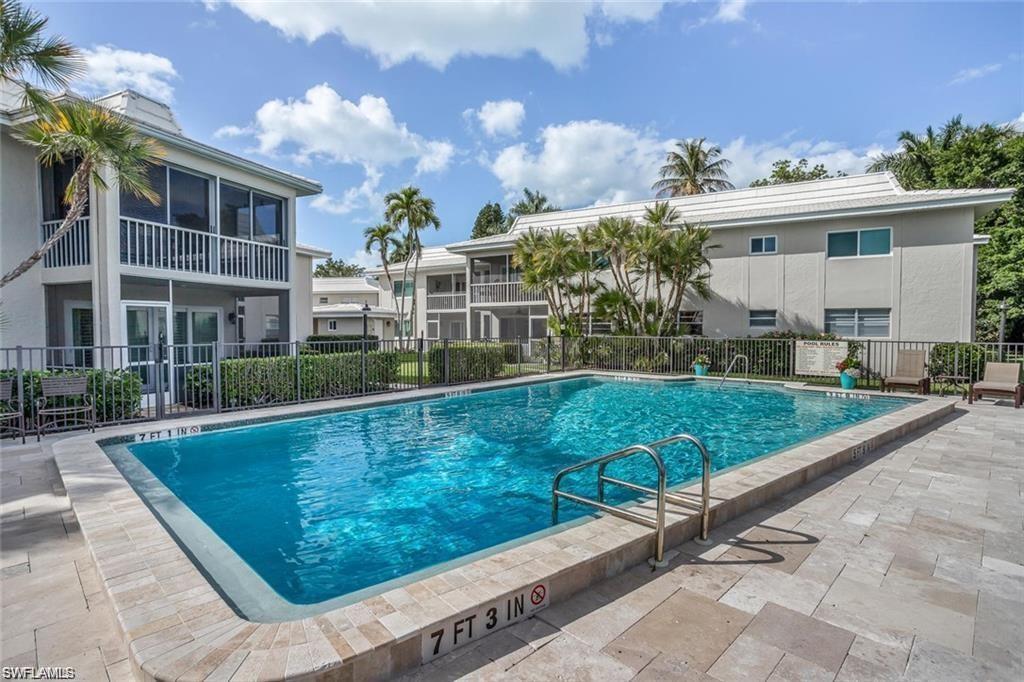 4160 Crayton Road, Unit A1 Naples, FL 34103 - Photo 10 of 17 a view of a patio with a table and chairs