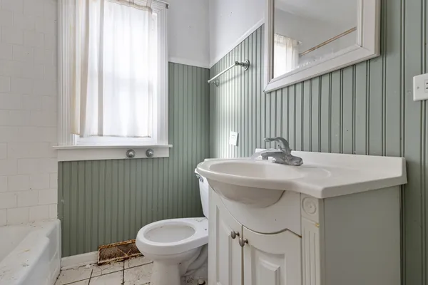 a bathroom with a sink a toilet and a mirror